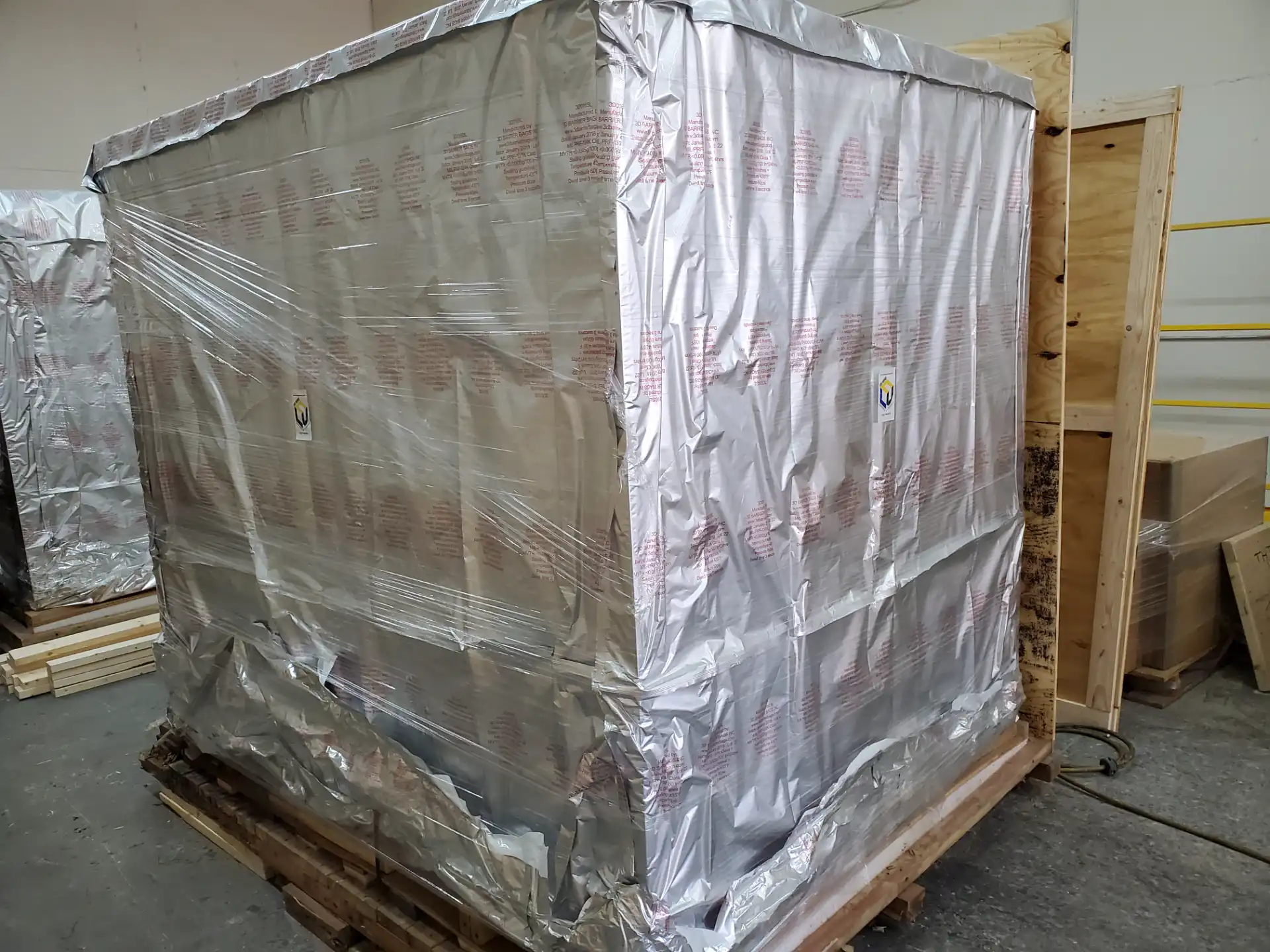 Vapor barrier wrapped items staged for shipment